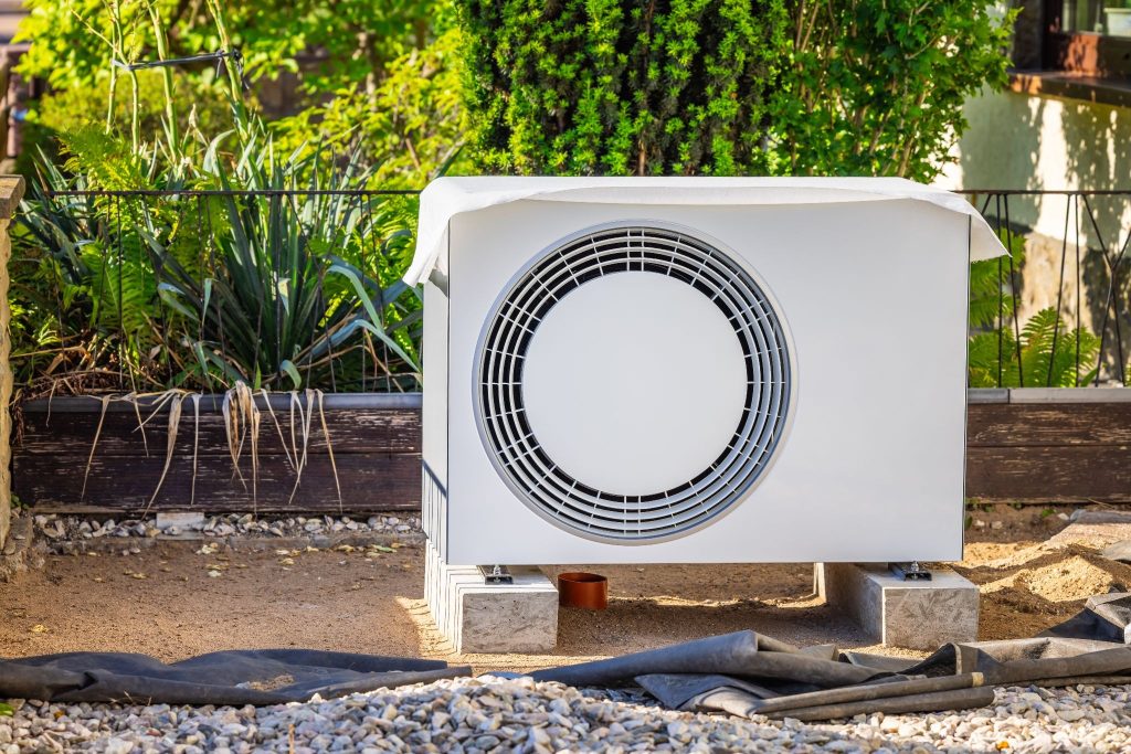 Air source heat pump unit installed outside a residential home awaiting scheduled service